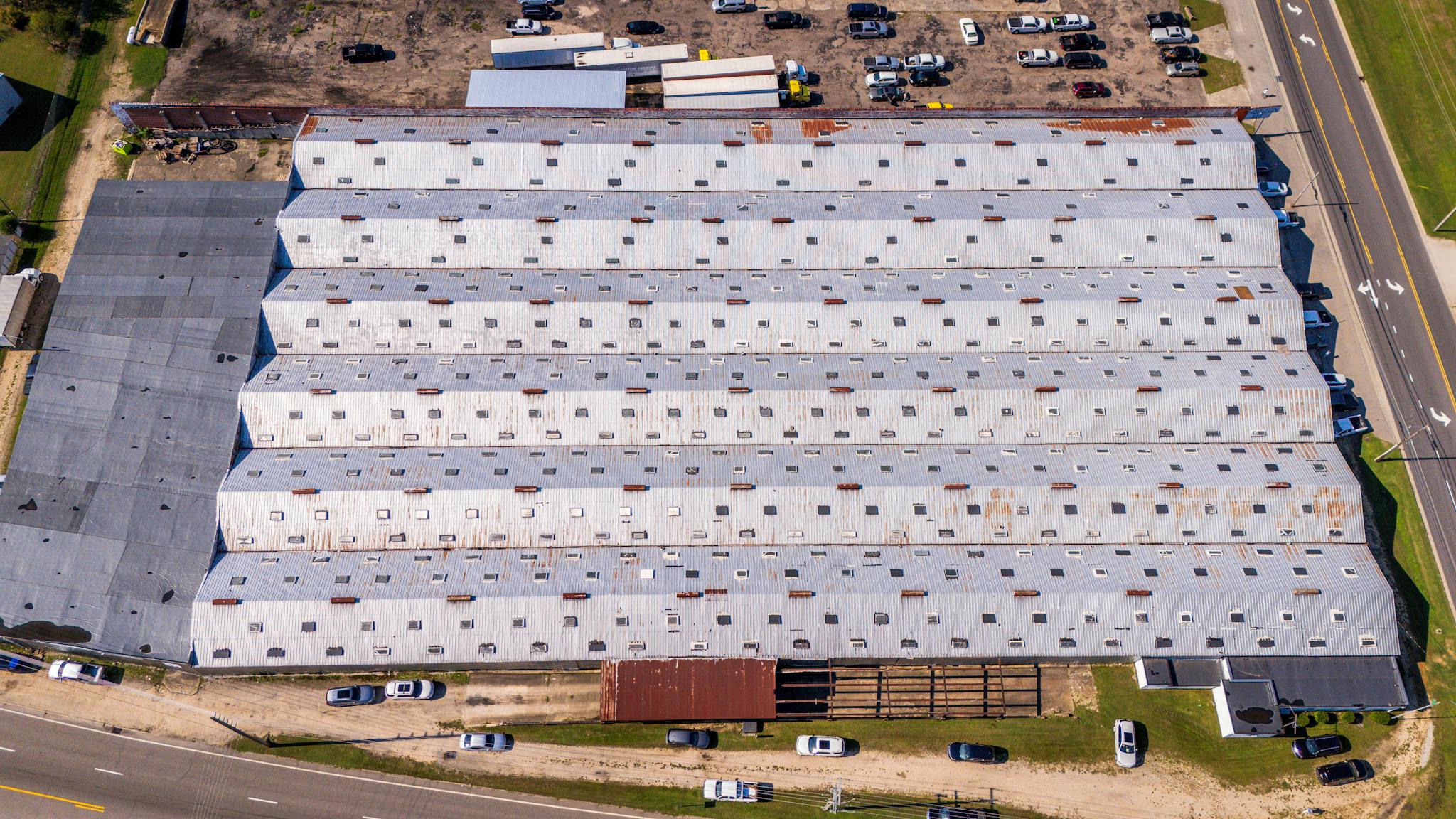 Aerial view of a large industrial warehouse with metal roofing in Wilson, North Carolina.